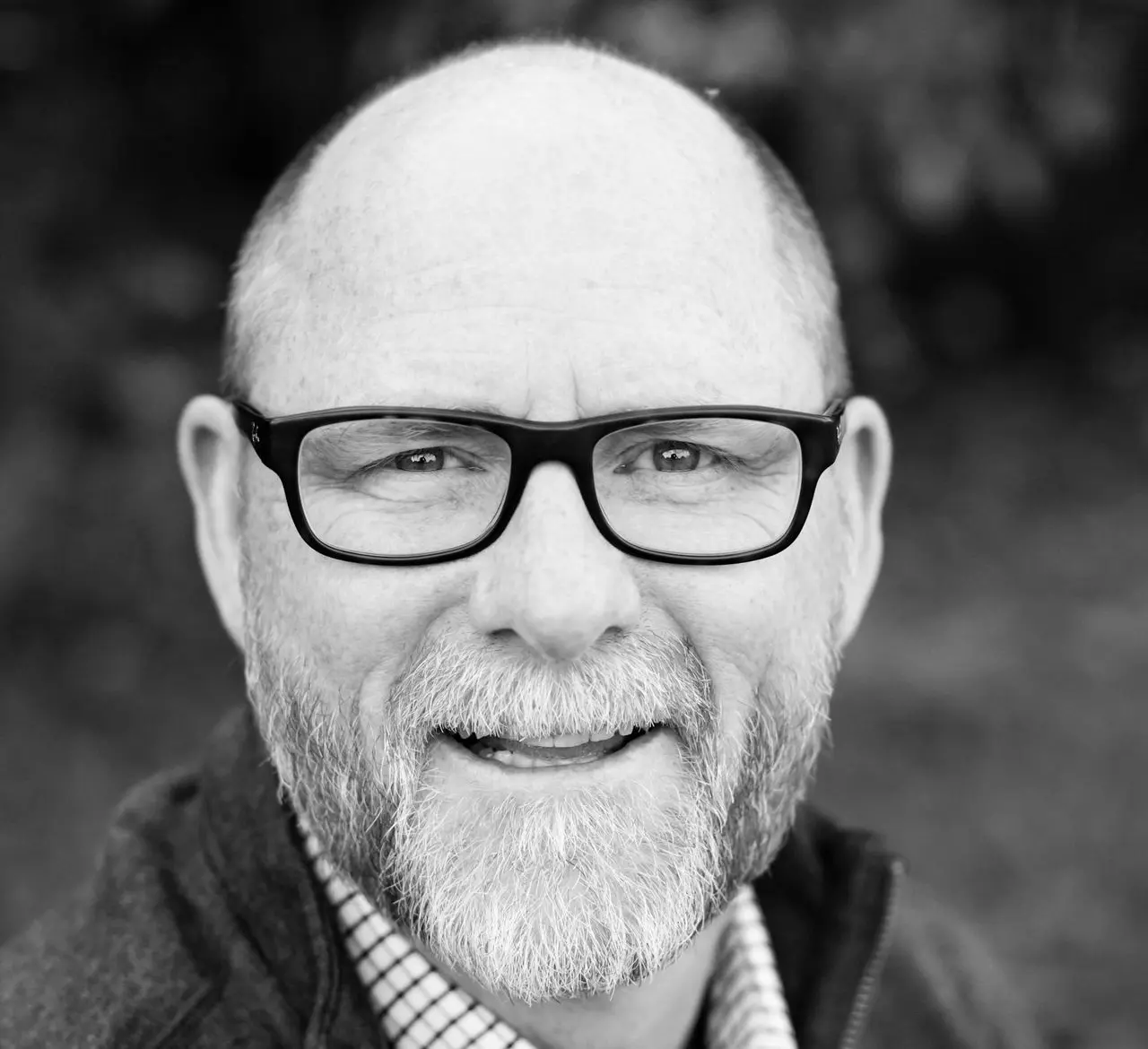 grayscale of man wearing eyeglasses